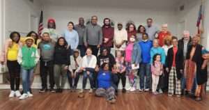 Group photo of about 50 diverse people.