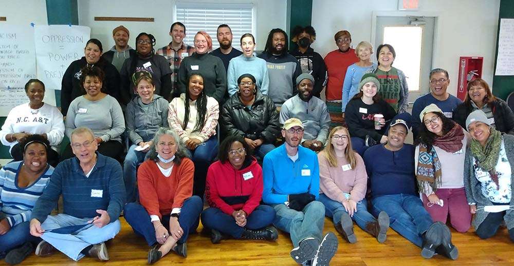 Group photo 3 rows of 30 people, very diverse, smiling