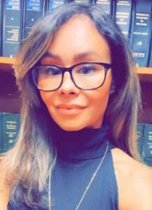 Portrait picture of a woman with glasses and long brown hair.