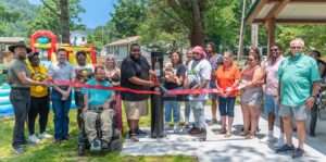 Group photo of ribbon cutting in front of drinking fountain in a public park
